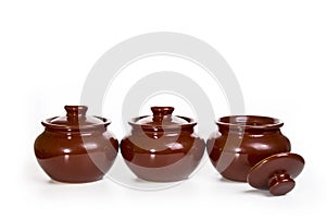 Three ceramic pots for oven isolated on white background