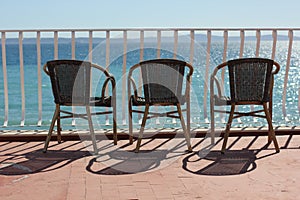 Three chairs in terace above colorful adriatic sea photo