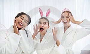 Three cheerful girls having fun at spa salon