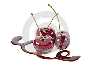 Three cherries in chocolate on white background