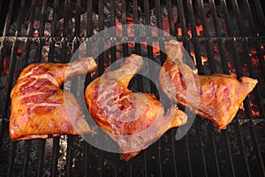 Three Chicken Leg Quarter Roasted On Hot BBQ Flaming Grill