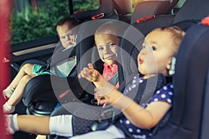 Three children in car safety seat