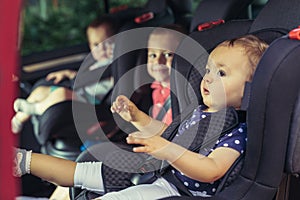 Three children in car safety seat