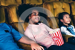 Three children having fun watching movie