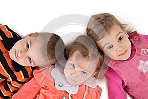 Three children lying top view close-up 2