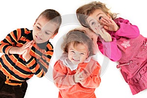 Three children lying top view close-up