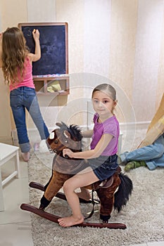 Three children playing in the gameroom