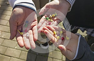 Three children show their hands full of bomblets photo