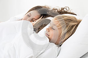 Three children sleeping in bed