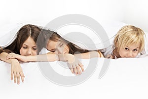 Three children sleeping in bed