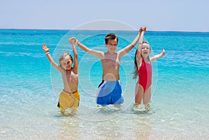 Three Children Wading in Ocean