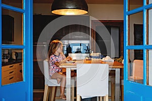 Three children watching sunrise on terrace or balcony. Two kids boys and preschool girl watch sun on horizon. Happy