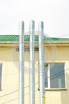 Three chimney smoke on building background