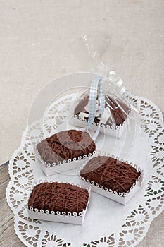 Three Chockolate Brownie on wooden kitchen board.