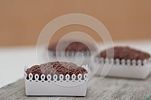 Three Chockolate Brownies On Wooden Kitchen Board