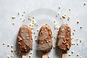 Three chocolate almond ice-cream on a wooden stick. Top view