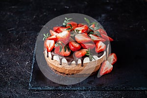 Three chocolates cake with chocolate drips on a black background. Layered cake with milk, black and white chocolate souffle