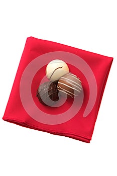 Three Chocolates on a red serviette