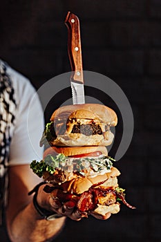 Three choices of tasty homemade burger with knife. Healthy falafel burger with fresh lettuce, savory grilled chicken with fresh cu