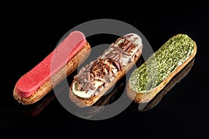 Three choux pastries with different fillings and decorations. photo