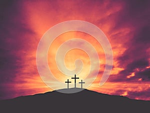 Three Christian Easter Crosses on Hill of Calvary with Colorful Clouds in Sky