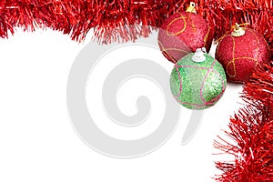 Three Christmas baubles with red tinsel