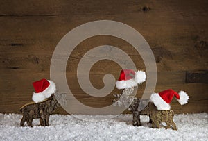 Three christmas reindeer of handmade wood with red white santa h