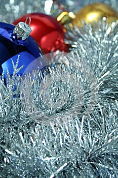 Three christmas sparkling spheres on a tinsel