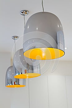 Three chrome and yellow contemporary kitchen pendant lighting