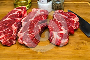 Three Chuck Steaks on Cutting Board