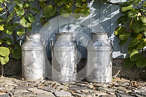 Three churns on a farm photo