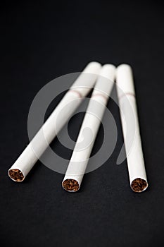 Three cigarettes on the black background