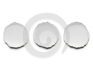 Three circular decorative white objects in a row