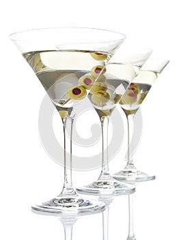 Three classic dry martini with olives isolated on white background