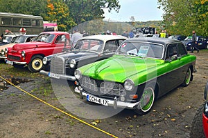 Three classic vintage oldtimer cars Volvo, Mercedes Benz and Warszawa 223 at a car show