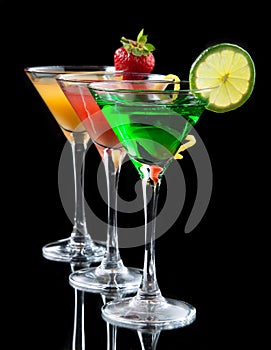 Three cocktails cosmopolitan cocktails decorated with citrus lemon