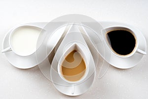Three coffee cups on white stone table 1