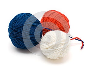 Three coil of yarn in red, blue and white