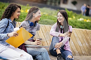 Three collage girls studying outside