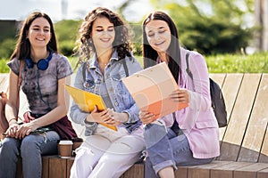 Three collage girls studying outside