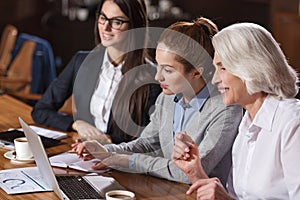 Three colleagues concentrating on work in an office