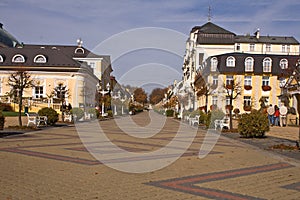 Three color brick driveway between buildings.