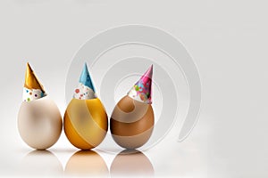 three color eggs with bithday hat