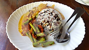 Three color rice with spicy yellow curry with pork and Stir fried pork belly and red curry paste with string bean in white dish