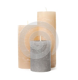 Three color wax candles on white