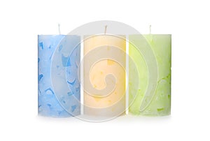 Three color wax candles on white