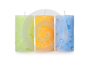 Three color wax candles on white