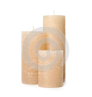 Three color wax candles on white