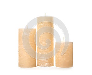 Three color wax candles on white