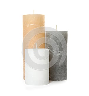 Three color wax candles on white
